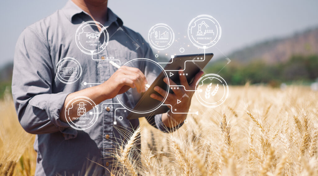 Modern farmer future agricultural industry technology 4.0, artificial intelligence (AI), 5g tablets to analyze data of smart farms, control the quality of plants in the soil produces precise results.